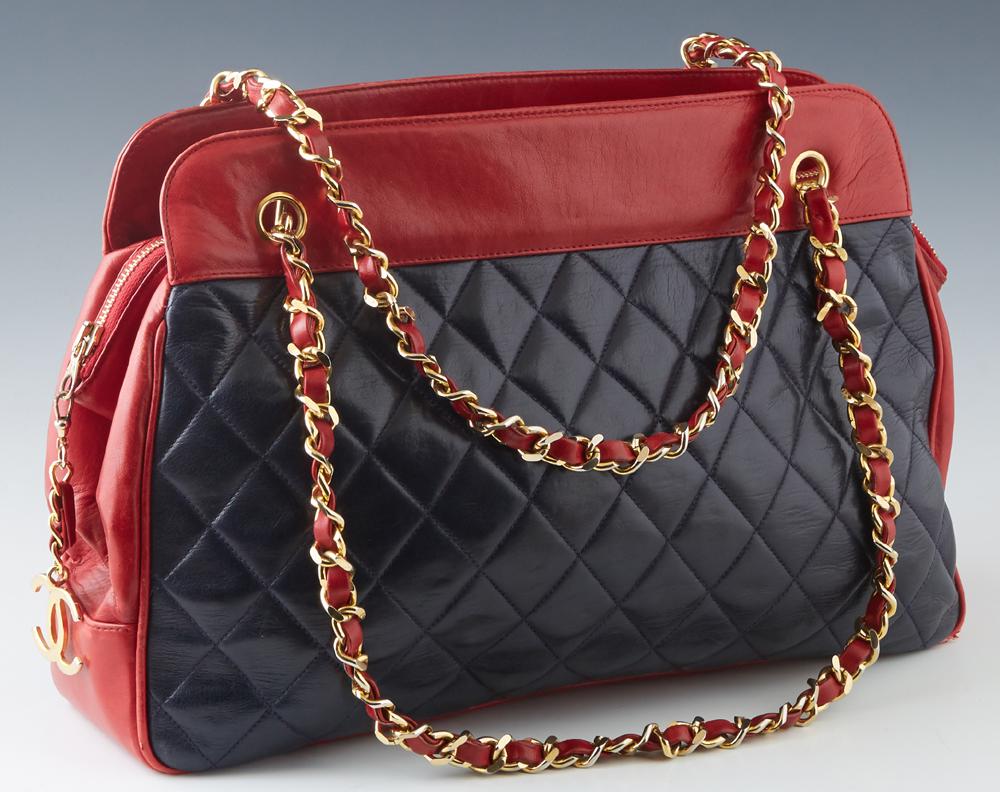 Chanel Black and Red Lambskin Chain Shoulder Bag, with: Chanel Black and Red Lambskin Chain Shoulder Bag, with gold tone hardware and zip closure, the interior of the bag lined in red leather with two zip closures on either side, flanked by two open storag