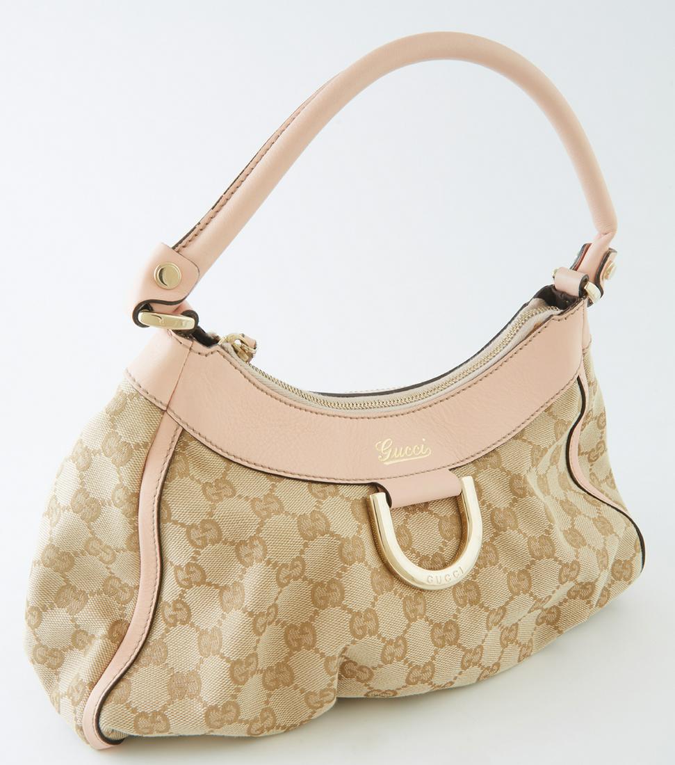 Gucci Powder Pink Leather and Beige Monogramed Canvas: Gucci Powder Pink Leather and Beige Monogramed Canvas PM D-Ring Hobo Handbag, the exterior with gold hardware, opening to a brown interior with side zip pocket, H.- 7 1/2 in., W.- 13 in., D.- 7 in., H
