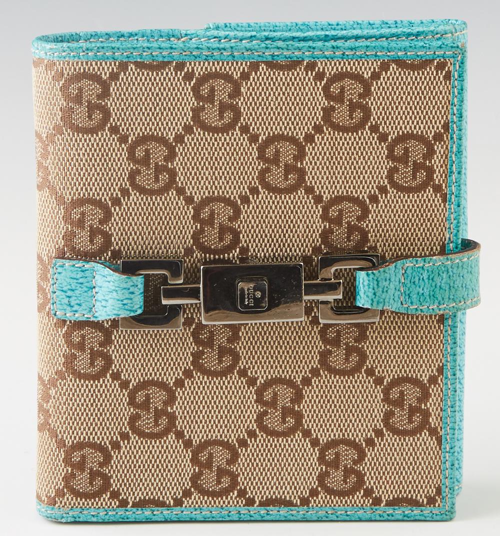 Gucci Compact GG Canvas Leather Jackie Wallet, with gun: Gucci Compact GG Canvas Leather Jackie Wallet, with gun metal hardware and push release closure, the interior lined in teal leather with numerous card slots and two large open storage pockets, with an