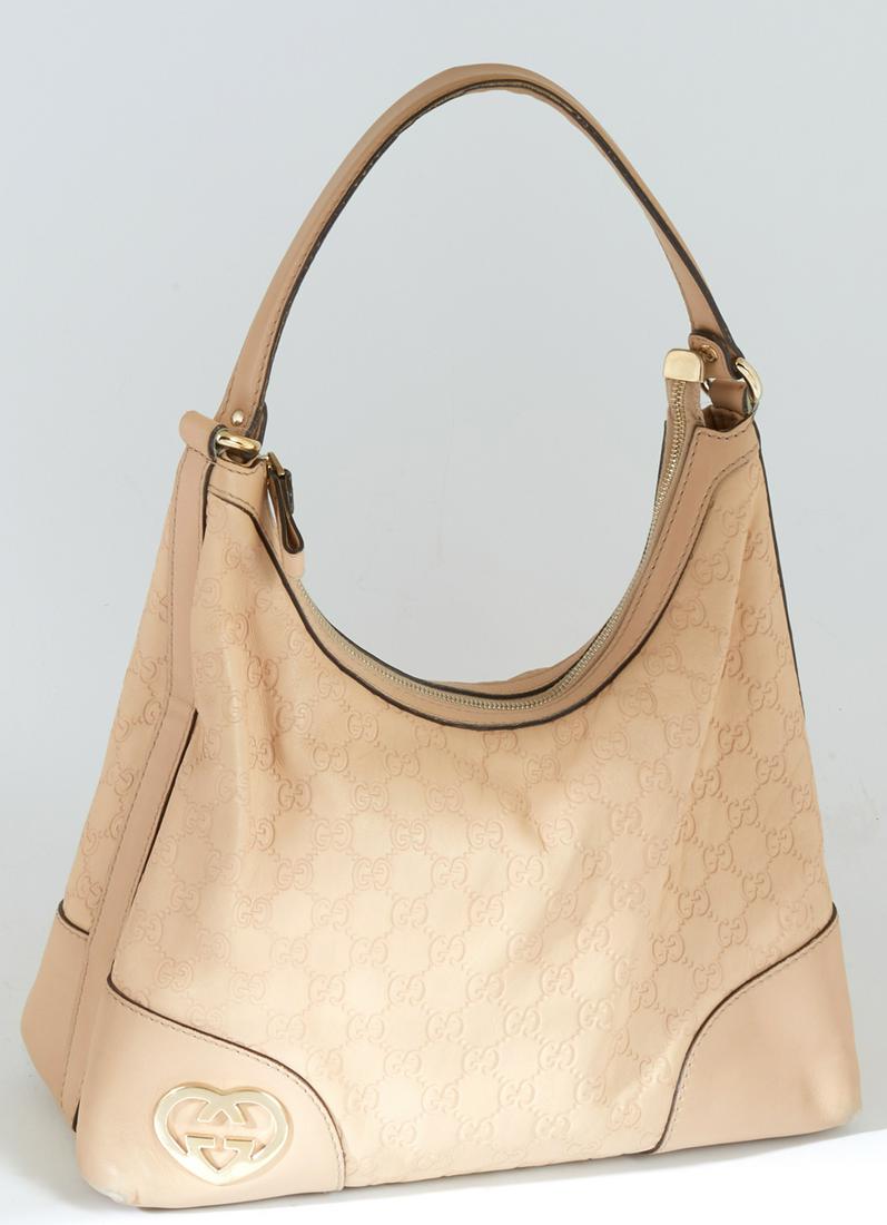 Gucci Light Pink Guccissima Leather PM Interlocking: Gucci Light Pink Guccissima Leather PM Interlocking Hearts Tote Shoulder Bag, with golden brass hardware and Gucci interlocking heart logo, opening to a beige canvas interior with one zip compartment 