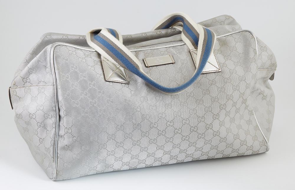 Gucci Silver Monogrammed Canvas Collapsible Carry-On: Gucci Silver Monogrammed Canvas Collapsible Carry-On Duffle Bag 40 Shoulder Bag, with blue, grey and white canvas straps, the top zip opening to a black lined interior with a side zip compartment, H.-