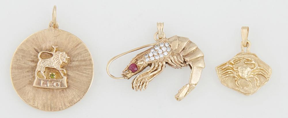 Group of Three 14K Yellow Gold Pendants, consisting of: Group of Three 14K Yellow Gold Pendants, consisting of a shrimp mounted with a red stone and small round diamonds; a "Leo" zodiac pendant mounted with a faux diamond; and a "Cancer" zodiac pendant, Sh