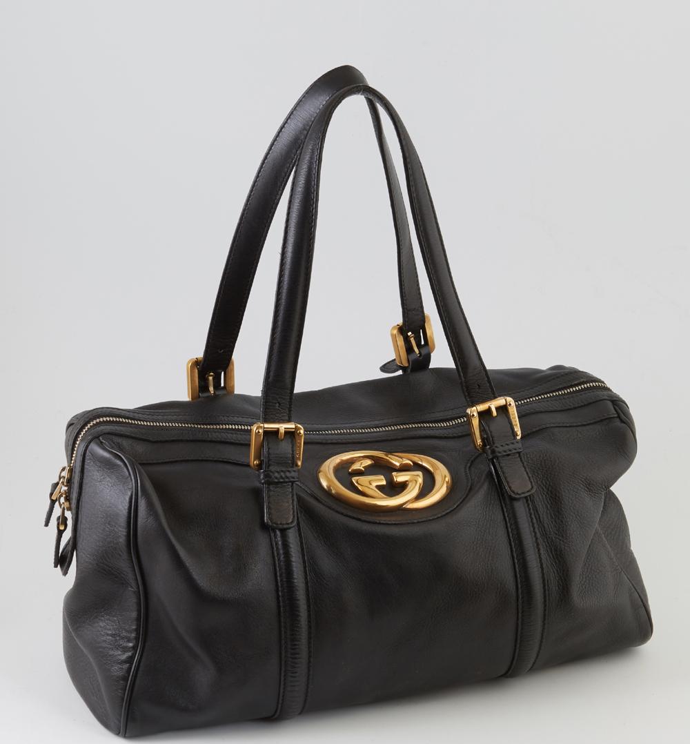 Gucci Black Smooth Leather Britt Boston Shoulder Bag,: Gucci Black Smooth Leather Britt Boston Shoulder Bag, the exterior with golden brass hardware and large Gucci logo, the top zipper opening to a green and red Gucci print lined interior with a side zip