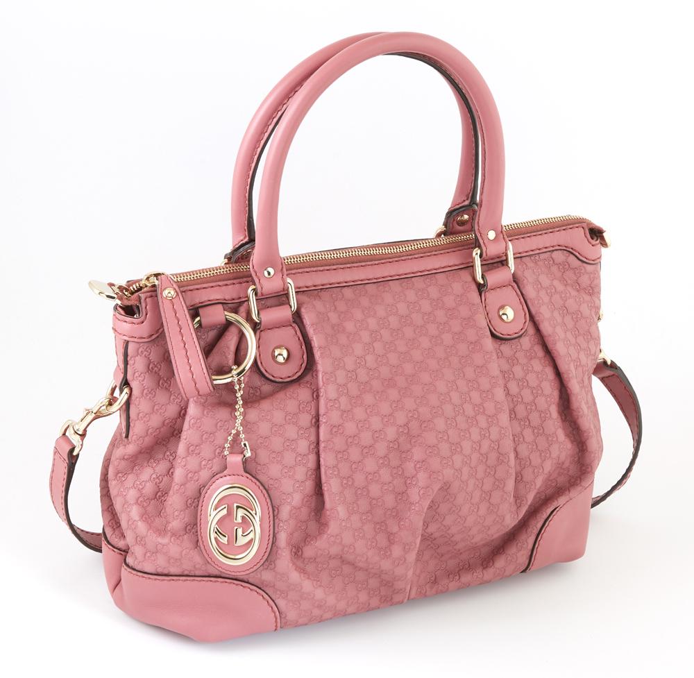 Gucci Pink Micro Guccisima Leather PM Sukey Top Handle: Gucci Pink Micro Guccisima Leather PM Sukey Top Handle Shoulder Bag, with gold hardware and hanging Gucci charm, the exterior with a detachable and adjustable leather strap, the top zipper opening to 