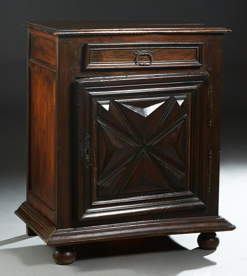 French Provincial Louis XIII Style Carved Oak: French Provincial Louis XIII Style Carved Oak Confiturier, 19th c., the stepped rounded edge top over a frieze drawer and a lower cupboard door with iron fiche hinges and escutcheons and applied geome