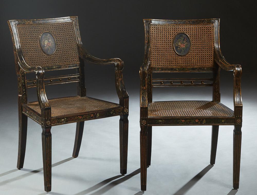 Pair of Italian Ebonized Caned Fauteuils, late 19th c.,: Pair of Italian Ebonized Caned Fauteuils, late 19th c., with gilt and painted floral decoration, the canted curved caned backs to scrolled arms, on trapezoidal caned seats, on reeded tapered square le