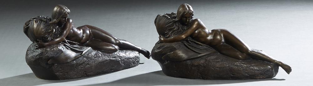 Pair of Patinated Bronze Figural Candlesticks,: Pair of Patinated Bronze Figural Candlesticks, 20th/21st c., with a reclining female nude holding the candle cup, H.- 6 3/4 in., W.- 12 1/2in., D.- 4 1/2 in.