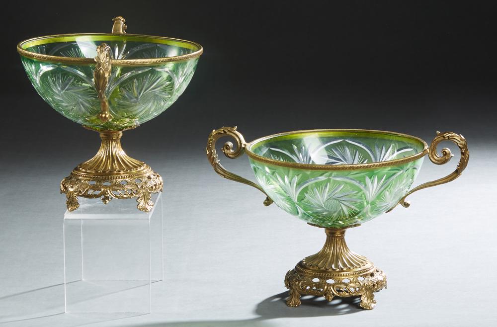Pair of Bronze Mounted Green Cut-to-Clear Glass Center: Pair of Bronze Mounted Green Cut-to-Clear Glass Center Bowls, 20th c., on reeded socle supports, to a pierced base on four splayed leaf form feet, H.- 8 1/2 in., W.- 12 3/4 in., D.- 8 3/4 in.