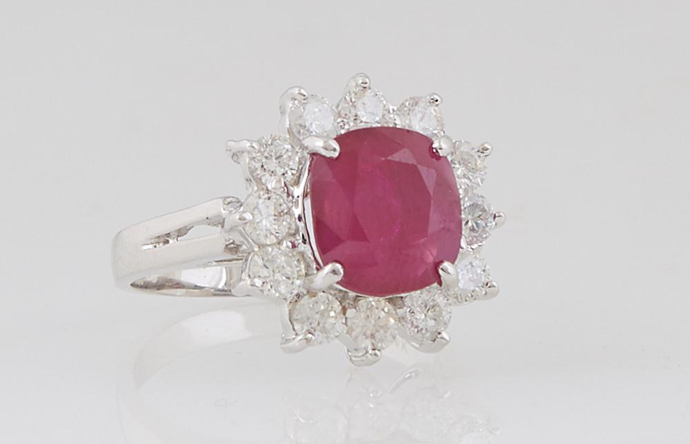 Lady's 14K White Gold Dinner Ring, with a 2.89 ct.: Lady's 14K White Gold Dinner Ring, with a 2.89 ct. cushion cut ruby atop a border of round diamond "points," total diamond wt.- .96 cts., Size 5 1/4, with appraisal.