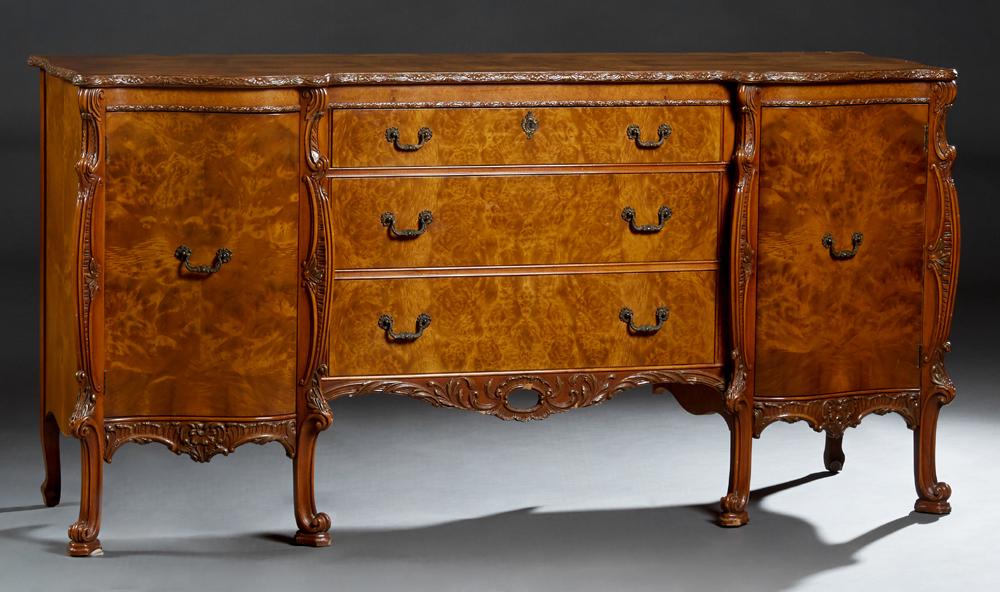 American English Style Burled Walnut Sideboard, early: American English Style Burled Walnut Sideboard, early 20th c., the serpentine carved edge top over a central bank of three drawers, flanked by serpentine door cupboards, on scrolled reeded legs, joine