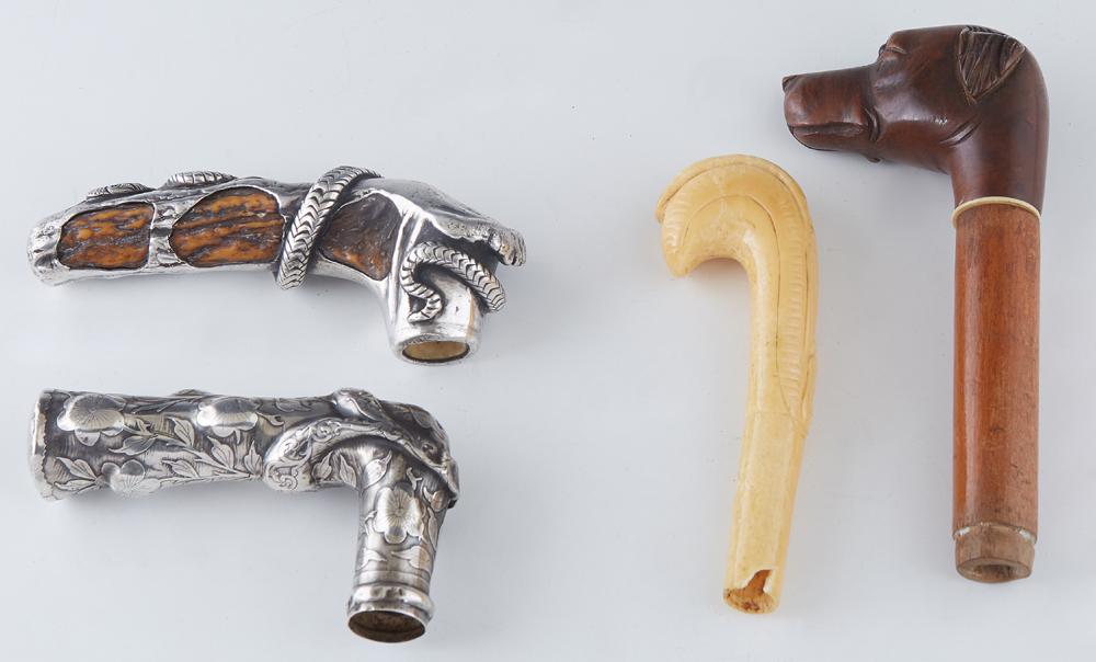 Group of Four Cane or Umbrella Handles, early 20th c.,: Group of Four Cane or Umbrella Handles, early 20th c., one of antler mounted with a coiled sterling snake; one sterling with relief floral decoration; a carved bone "L" shaped example; and a dog head 