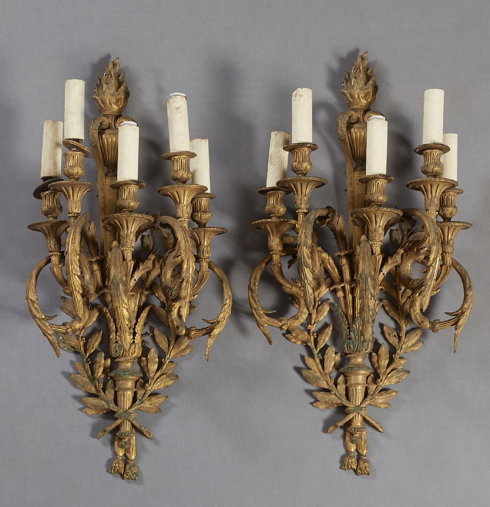 Pair of Large Impressive Louis XVI Style Gilt Bronze: Pair of Large Impressive Louis XVI Style Gilt Bronze Five Light Wall Sconces, early 20th c., the flaming torch back plate issuing five curved leaf relief decorated arms with bobeches and candle cups, 