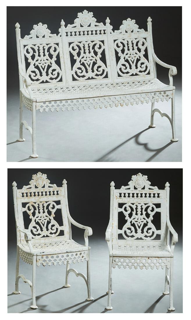 Three Piece American Victorian Cast Iron Patio Set,: Three Piece American Victorian Cast Iron Patio Set, late 19th c., consisting of a settee and two armchairs, with pierced floral relief crests over pierced backs, flanked by scrolled arms above pierced