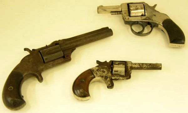 Three Small Handguns, 19th c.- a .32 cal. revolve: Three Small Handguns, 19th c.- a .32 cal. revolver by H & R Arms, with a molded handle; a .22 cal. derringer with wooden handles; and a .32 cal. revolver by Smith & Wesson, with wooden handles.
