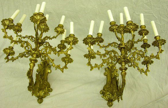 Pair of Bronze Ten Light Candle Sconces, 20th c., t: Pair of Bronze Ten Light Candle Sconces, 20th c., the curved arms with relief grape and leaf decoration, on high floral and leaf relief back plates, H.- 22 1/2 in., W.- 18 in., D.- 25 3/4 in.