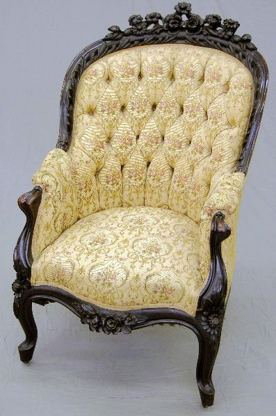 Victorian Carved Mahogany Bergere, c. 1890, with a: Victorian Carved Mahogany Bergere, c. 1890, with a pierce carved floral crest above a leaf carved tufted barrel back, to upholstered arms, with a floral carved skirt and cabriole legs with floral carv