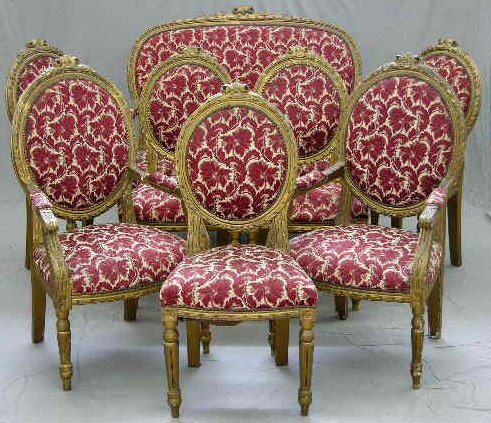 Eight Piece Louis XVI Style Carved Gilt Wood Parlo: Eight Piece Louis XVI Style Carved Gilt Wood Parlor Suite, c. 1900, consisting of a settee, 2 fauteuils and 6 side chairs, all with floral carved crests above medallion backs, with floral upholstery a