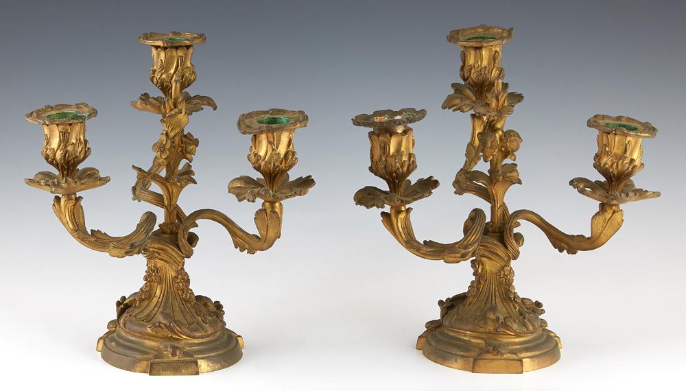 Pair of Louis XV Style Gilt Bronze Three Light: Pair of Louis XV Style Gilt Bronze Three Light Candelabra, 19th c., #49451, with three swirled leaf form supports with floral relief candle cups and leaf form bobeches, around a central floral spire, 