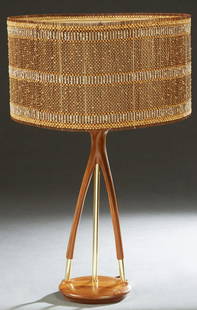 Mid-Century Modern Teak and Brass Table Lamp, 20th c.,: Mid-Century Modern Teak and Brass Table Lamp, 20th c., the open wood "wishbone" support with a central brass rod, on a sloping circular base, with a Maria Kipp woven shade, H.- 18 in. to bottom of soc