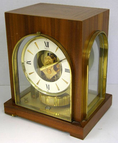 Unusual Mahogany Gruen Guild Atmos Mantel Clock, p: Unusual Mahogany Gruen Guild Atmos Mantel Clock, pre 1983, Ser. # 272746, the top with crotched veneers, H.- 9 3/4 in., W.- 8 3/8 in., D.- 6 1/2 in.