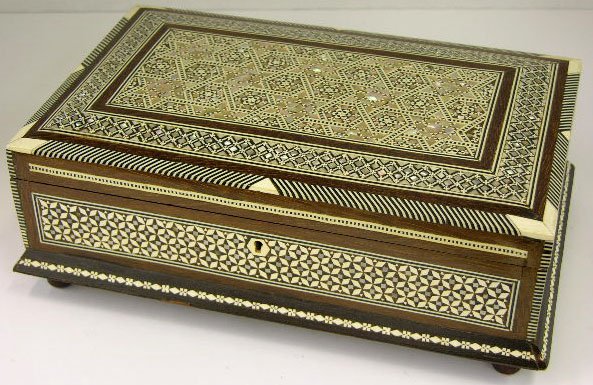 Middle Eastern Carved Mahogany Dresser Box, 20th c: Middle Eastern Carved Mahogany Dresser Box, 20th c., elaborately inlaid with mother-of-pearl and bone, the whole on turned bun feet, H.- 3 3/4 in., W.- 10 1/2 in., D.- 6 5/8 in.