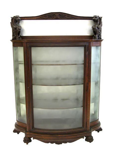 Carved Oak Eleven Piece Winged Gryphon Dining Room: Carved Oak Eleven Piece Winged Gryphon Dining Room Suite, c. 1900, probably by Horner,consisting of a Circular Table, Eight Chairs, Sideboard and Curved Glass Curio Cabinet, from the estate of Joseph