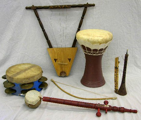Group of Six African Musical Instruments, 20th c.,: Group of Six African Musical Instruments, 20th c., a lute and bow, a drum with attached tambourine, a drum, a stringed instrument made from a coconut, a flute and a horn.