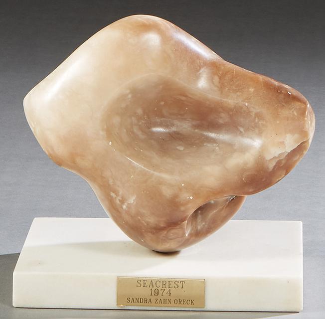 Sandra Zahn Oreck (1940-, American) "Seacrest," 1974, a: Sandra Zahn Oreck (1940-, American) "Seacrest," 1974, a carved taupe alabaster free-form tabletop sculpture on a rectangular, polished white Carrara marble base bearing an engraved brass title plaque,
