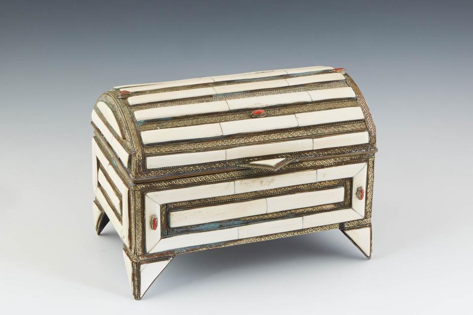 Middle Eastern Bone Mounted Iron Casket, 20th c., the: Middle Eastern Bone Mounted Iron Casket, 20th c., the arched top, front and sides with bone strips, the front and back with small oval cabochon coral stones, on triangular feet, H.- 7 1/2 in., W.- 10 