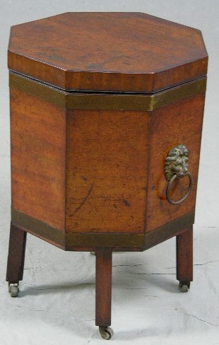 Edwardian Carved Mahogany Octagonal Cellaret, c. 19: Edwardian Carved Mahogany Octagonal Cellaret, c. 1910, with brass banding and brass lions' head ring handles, on square legs to brass castors, H.- 23 1/2 in., W.- 18 in., D.- 15 3/4 in.