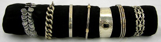 Group of Seven Sterling Silver Bracelets, 20th c.,: Group of Seven Sterling Silver Bracelets, 20th c., one by Pierre Cardin, with 14K yellow gold accents.