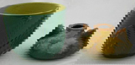 Small Roseville Handled Magnolia Vase, 20th c., un: Small Roseville Handled Magnolia Vase, 20th c., unsigned, H.- 2 1/8 in., W.- 4 1/2 in., D.- 4 1/8 in., together with a Roseville high glaze Mayfair planter, 1952, #1110-4, H.- 3 3/4 in., Dia.- 4 5/8 i