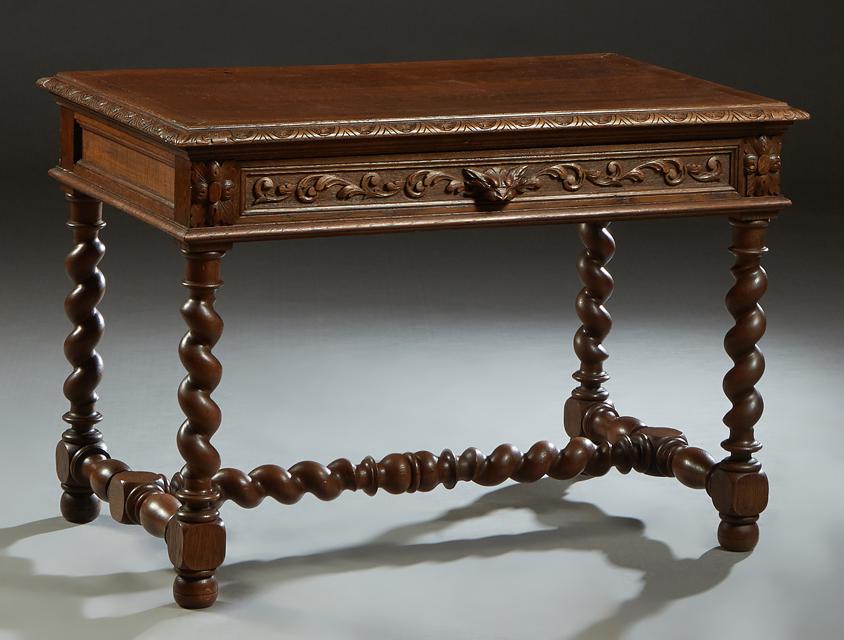 French Louis XIII Style Carved Oak Writing Table, late: French Louis XIII Style Carved Oak Writing Table, late 19th c., the stepped carved edge rectangular top over a wide skirt with one long frieze drawer, on rope twist legs joined by a block and rope twi