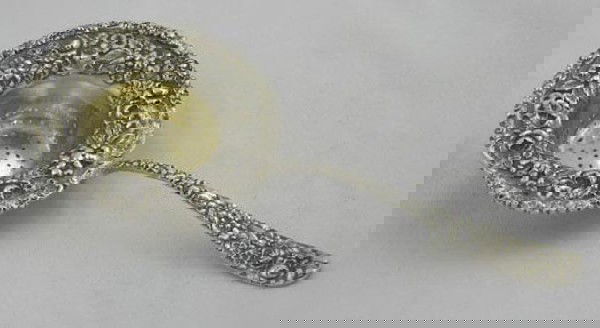 Sterling Tea Strainer, 20th c., with a flo: Sterling Tea Strainer, 20th c., with a floral repousse bowl and a floral relief handle, H.- 7 1/8 in., W.- 3 1/8 in.