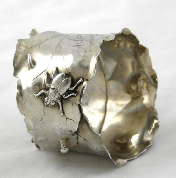 Unusual Sterling Napkin Ring, c. 1885, by : Unusual Sterling Napkin Ring, c. 1885, by George W. Shiebler, in the form of a pinned leaf with a relief bug, H.- 2 in., Dia.- 2 5/16 in.