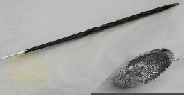 George III Sterling Punch Ladle, c. 1779,: George III Sterling Punch Ladle, c. 1779, the bowl with repousse decoration and the center with a George II silver coin, the long handle of twist carved ebony, H.- 1 in., W.- 13 3/8 in., D.- 2 13/16 i