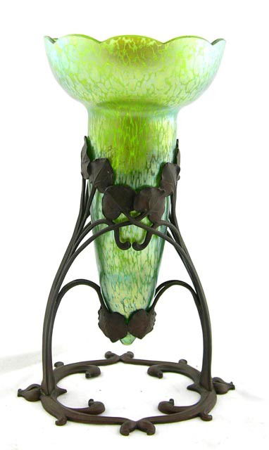 Iridescent Art Glass Art Nouveau Vase, c.: Iridescent Art Glass Art Nouveau Vase, c. 1900, with a scalloped rim, probably Loetz, in a bronze leaf form base, H.- 11 5/8 in., W.- 7 1/4 in., D.- 5 5/8 in.