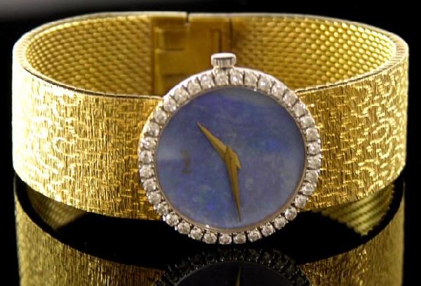 Piaget 18K Yellow Gold Lady's Wristwatc: Piaget 18K Yellow Gold Lady's Wristwatch, with a blue mother-of-pearl face and diamond mounted bezel, the flexible band also of 18K yellow gold, L.- 6 1/8 in.