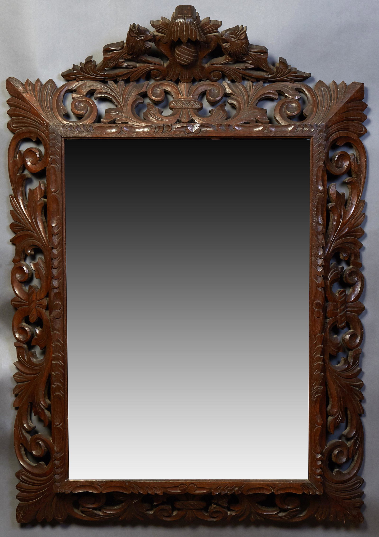 French Henri II Style Carved Beech Cushion Mirror,: French Henri II Style Carved Beech Cushion Mirror, early 20th c, with a lion and egg carved crest above a pierced leaf and scroll frame around a wide beveled mirror plate, H.- 51 in., W.- 34 in., D.- 