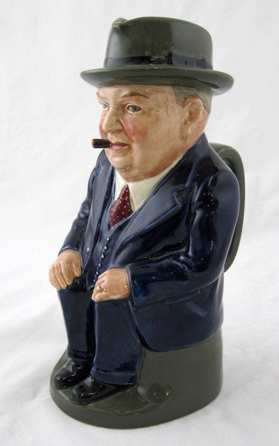 Royal Doulton "Cliff Cornell" Toby Jug, 20th c., th: Royal Doulton "Cliff Cornell" Toby Jug, 20th c., the underside marked Cliff Cornell "Famous Cornell Fluxes," Cleveland Flux Co., H.- 9 3/8 in., W.- 6 1/4 in., D.- 5 in.