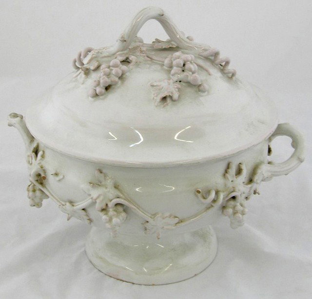 Italian Faience Soup Tureen, late 19th c., with re: Italian Faience Soup Tureen, late 19th c., with relief vintage motif decoration, the lid and side handles of tendril form, H.- 11 in., W.- 12 1/2 in., D.- 11 1/2 in.