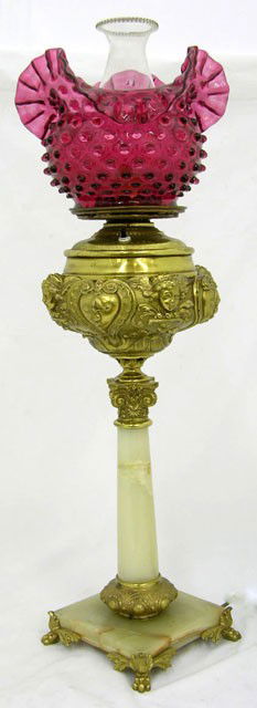 Victorian Brass Banquet Oil Lamp, 19th c., the rep: Victorian Brass Banquet Oil Lamp, 19th c., the repousse font with floral and putti decoration, on a tapered green onyx support, on a square green onyx base with metal paw feet, the oil regulator marke