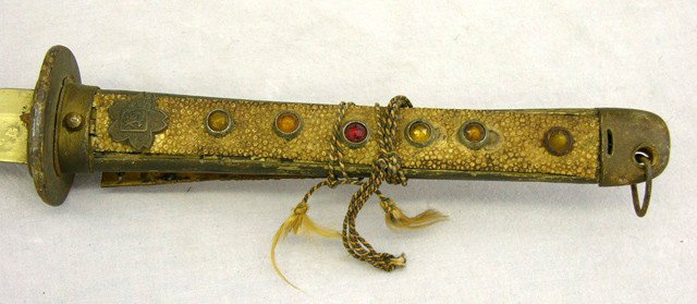 Samurai Sword, mid 20th c., with faux shagreen han: Samurai Sword, mid 20th c., with faux shagreen handles mounted with faux jewels, in a lacquered wooden scabbard, L.- 41 in.