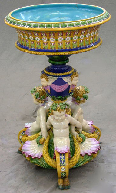 Large Minton's Majolica Jardiniere on Stand, 19th : Large Minton's Majolica Jardiniere on Stand, 19th c., with a floral relief bowl with aqua interior on a baluster urn support with relief winged putti heads, to a base with three male fauns with floral