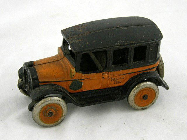 "Arcade" Cast Iron Yellow Cab Toy, early 20th c., : "Arcade" Cast Iron Yellow Cab Toy, early 20th c., impressed "Arcade," and "No. 3," driver's side with an applied paper label "An Arcade Toy," now lacking the driver and undercarriage, H.- 2 7/8 in., W