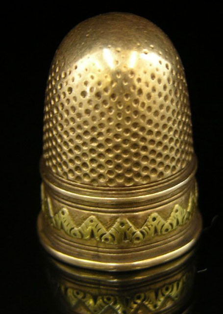 Yellow Gold Thimble, 19th c., with relief decorati: Yellow Gold Thimble, 19th c., with relief decoration, H.- 1 in., Dia.- 11/16 in., wt.- .16 troy oz.