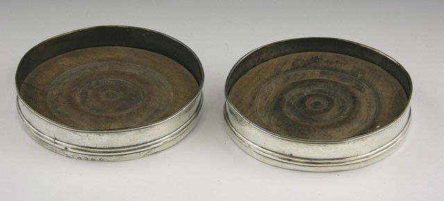 Pair of Georgian Sterling Rim Wine Bottle Coasters: Pair of Georgian Sterling Rim Wine Bottle Coasters, London, 1788, by George Smith, monogrammed "JAC," with turned mahogany bottoms, H.- 1 in., Dia.- 4 7/8 in.