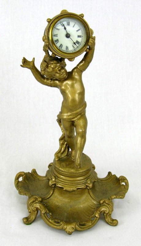 Ansonia Gilt Spelter Mantel Clock, c. 1900, the cl: Ansonia Gilt Spelter Mantel Clock, c. 1900, the clock supported on the head of a putto, on a shell form tripartite base, on four cabriole legs, H.- 12 1/2 in., W.- 7 1/4 in., D.- 5 1/2 in.