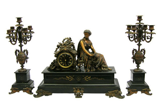 Three Piece Patinated Spelter and Black Granite Cl: Three Piece Patinated Spelter and Black Granite Clock Set, c. 1880, the clock with a seated female classical figure, over a black enamel face, above a front gilt incised panel, the whole on scrolled f