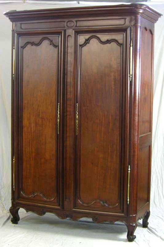 French Provincial Carved Walnut Armoire, 18th c., : French Provincial Carved Walnut Armoire, 18th c., with an ogee crown over double shaped panel doors, with brass escutcheons and fiche hinges, on cabriole legs to scrolled feet on French toes, joined b